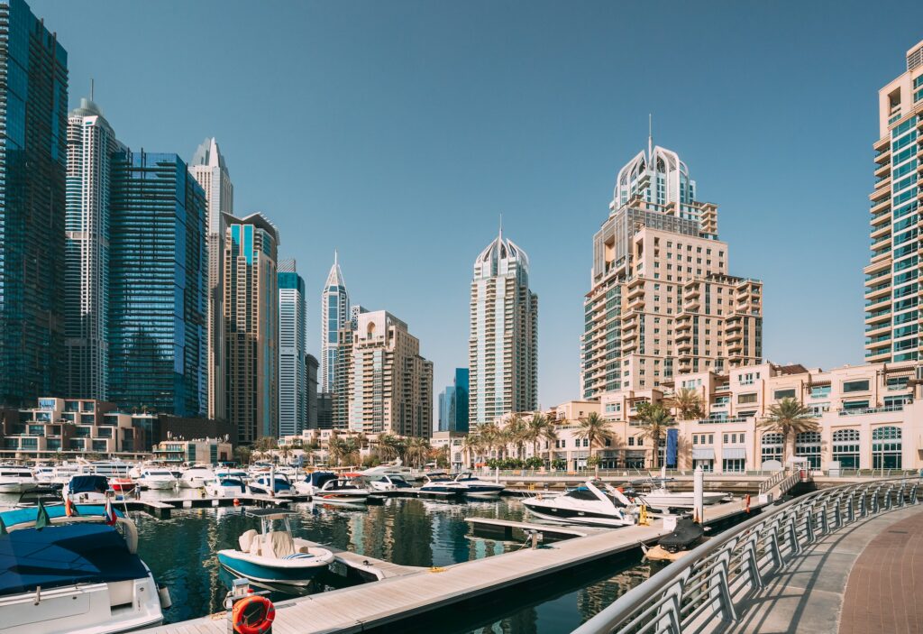 Yachts are moored at city pier, jetty in Dubai Marina